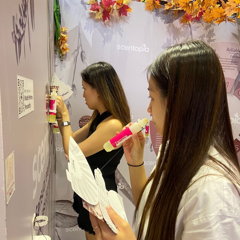 Friends creating personalized fragrances during a birthday perfume-making event