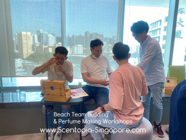 male members of team crafting scent at scentopia team building