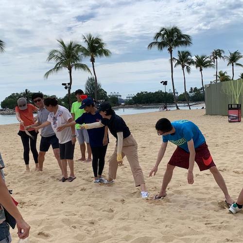 human chain as Strategic Problem Solving During Corporate Beach Team Building - Sentosa