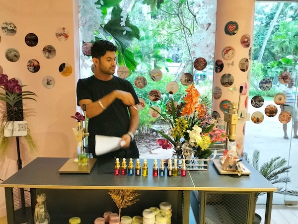 perfume explaining orchid and its scents to tourists at scentopia